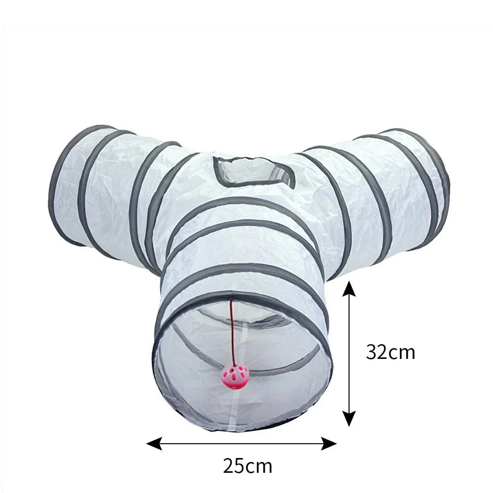 A white collapsible indoor play tunnel for cats with striped sections and a hanging ball.