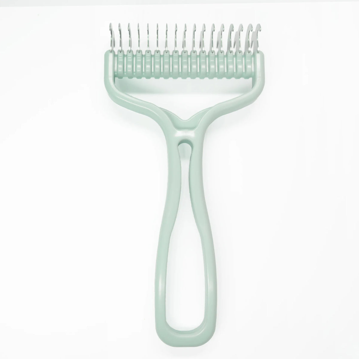 A light green pet hair removal comb with a curved handle and multiple teeth for grooming dogs and cats.