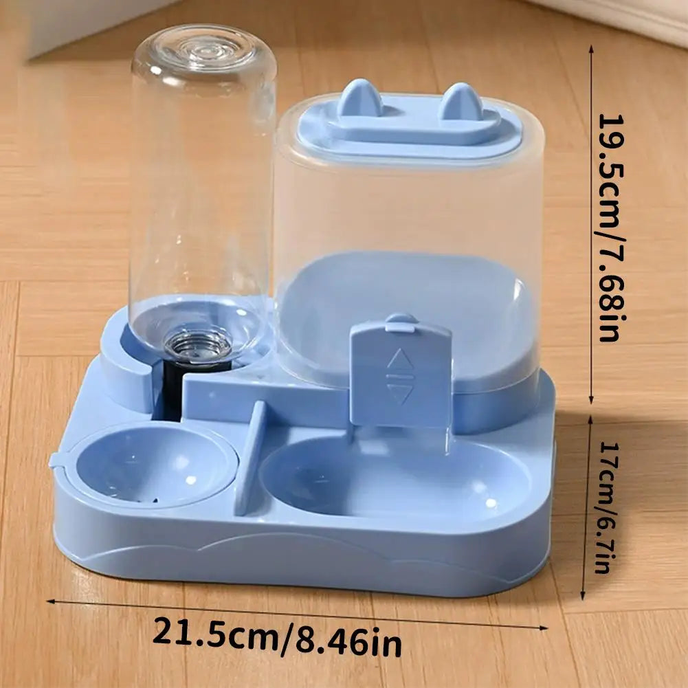 A light blue gravity-fed pet food dispenser with a water bowl for cats and small dogs, shown on a wooden surface.