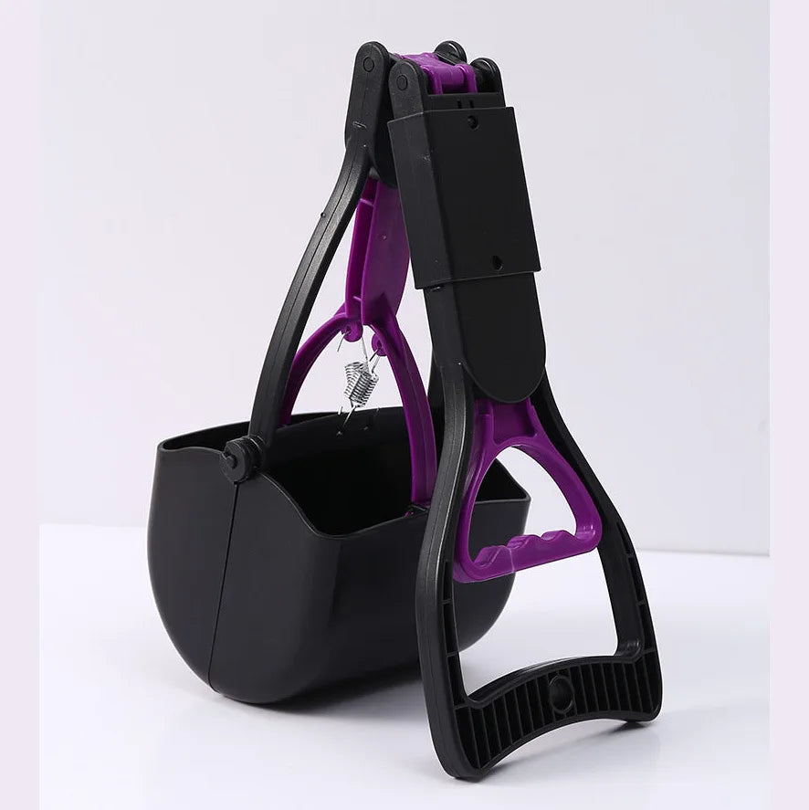 A black and purple foldable pet poop scooper tool is shown against a white background.