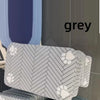 A stack of grey and white patterned pet feeding mats.