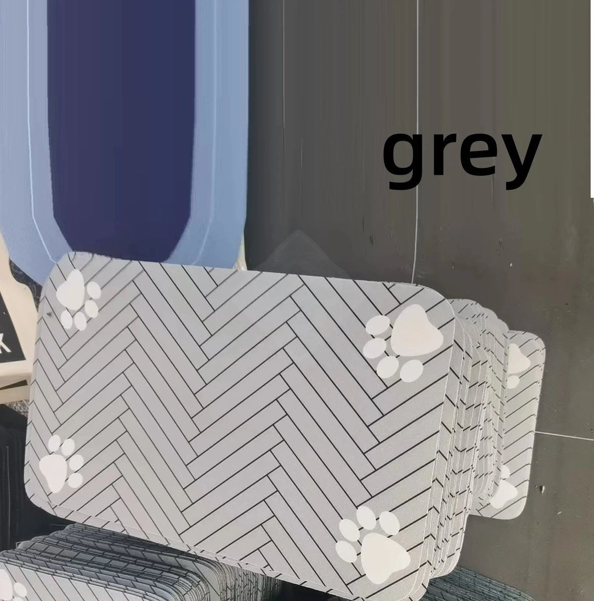 A stack of grey and white patterned pet feeding mats.