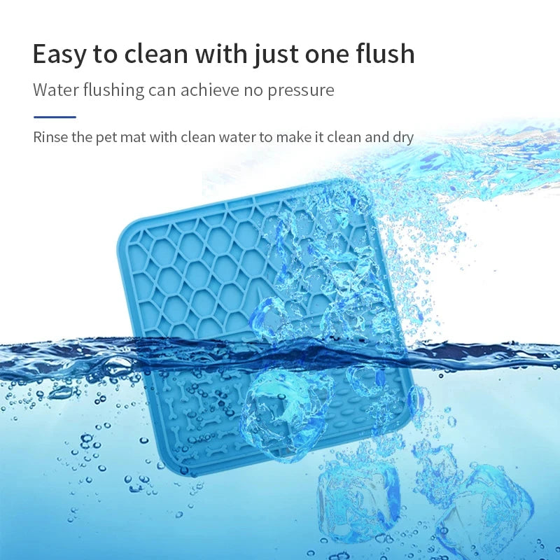 A blue silicone pet licking mat with suction cups being rinsed with water.