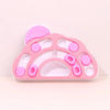 Jouet distributeur interactif rose pour chien et chat avec compartiments de différentes formes pour les friandises.