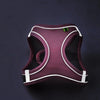 A maroon reflective adjustable pet harness is shown against a dark background.