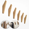 Three wooden coat hooks mounted on a wall, showing the natural grain of oak wood.