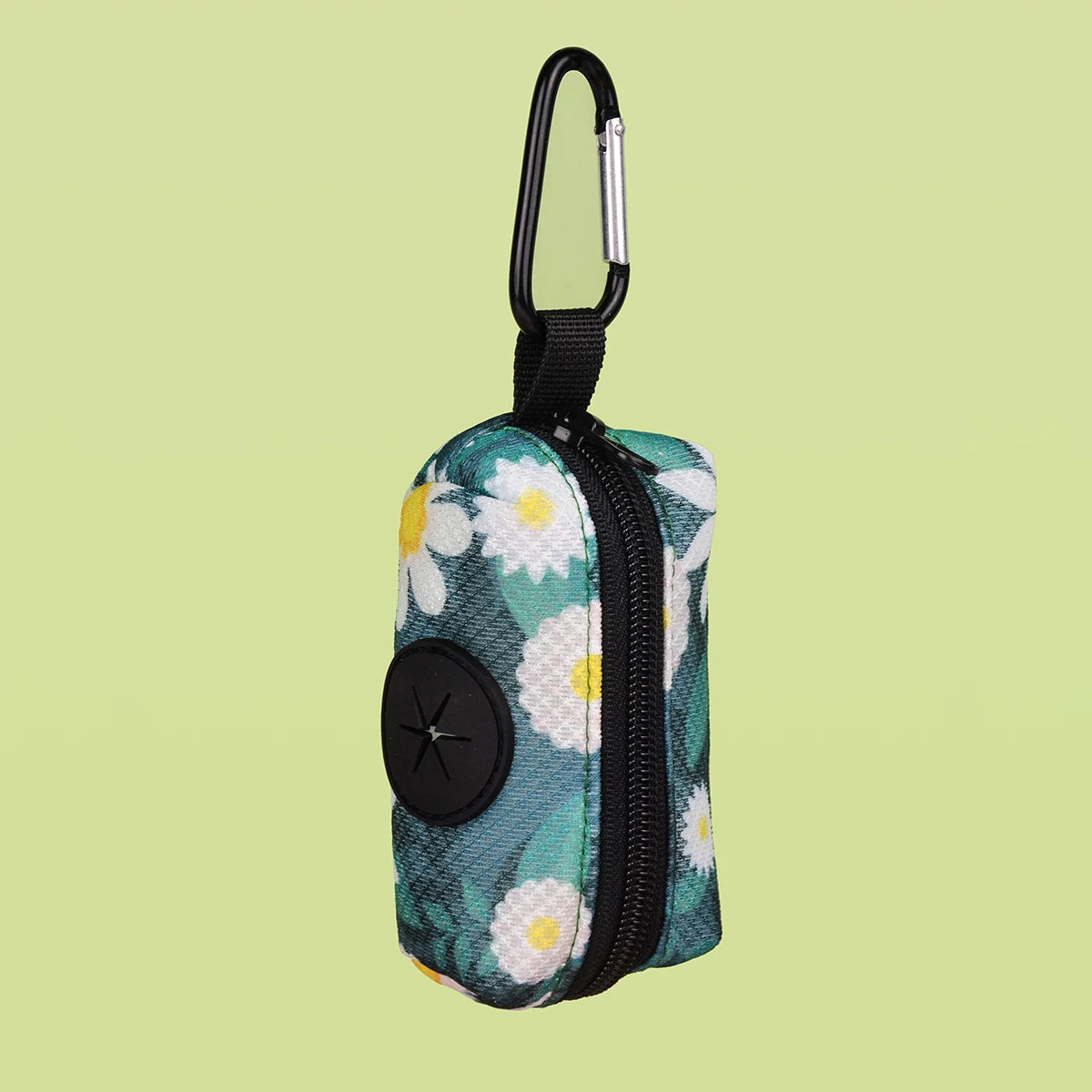 A small, zippered poop bag dispenser featuring a light blue and white floral pattern on a green background.