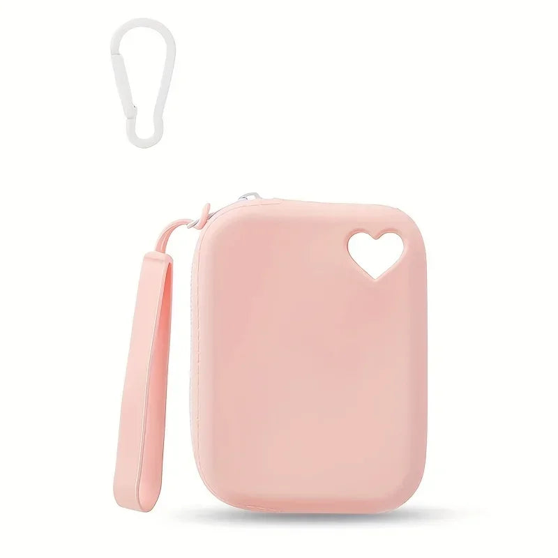 A pink silicone dog treat pouch with a heart cutout and a white loop attached.