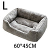 A gray plush pet bed with a rounded, cushioned design shown from above.