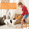 A young girl interacts with a dog using a squeaky octopus dog toy made of crinkle paper sounds.