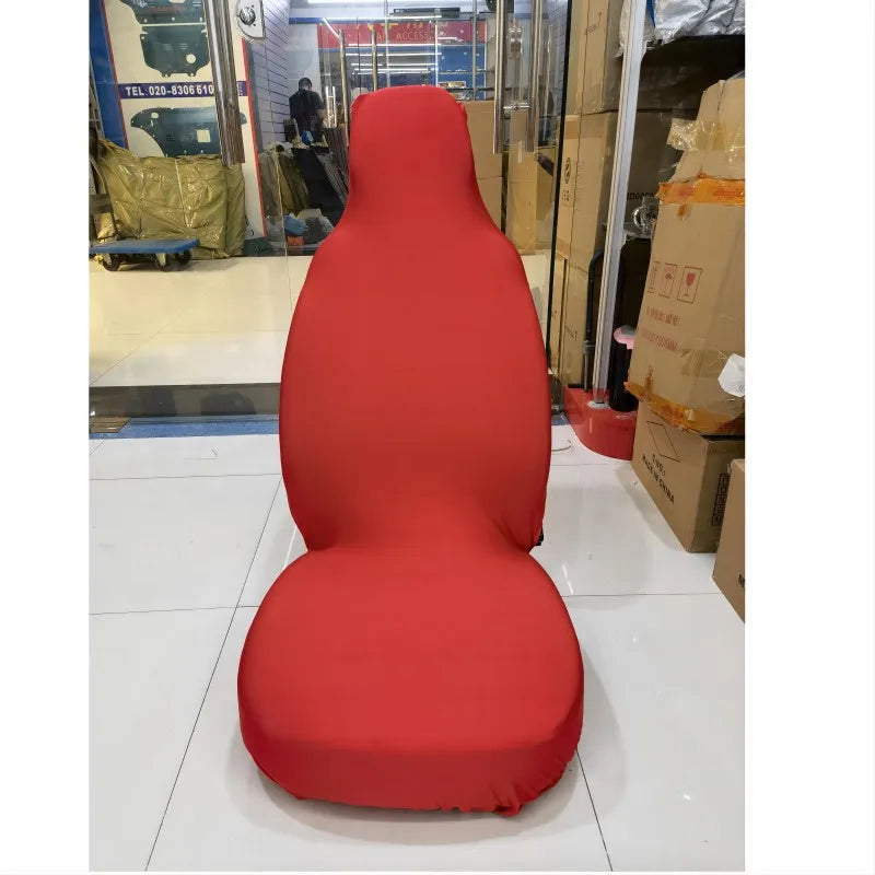 A bright red breathable stretch car seat cover displayed on a white floor.