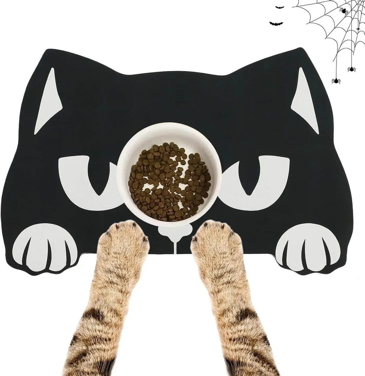 A black pet feeding mat shaped like a cat with white paws and eyes, featuring a spider web design.