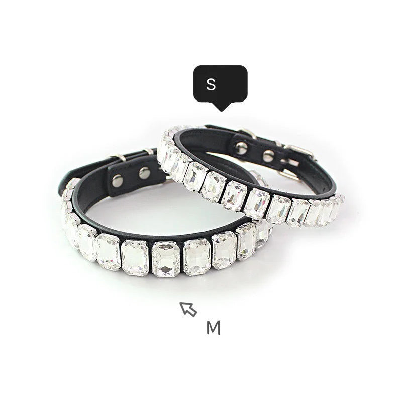 A pair of black dog collars adorned with sparkling clear rhinestones and crystal accents.