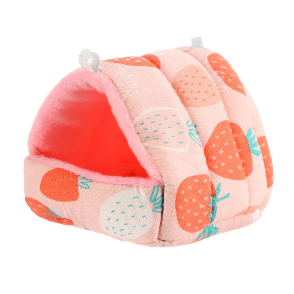 A pink flannel pet nest bed shaped like a strawberry with orange accents and a pink interior.