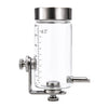 A clear glass and stainless steel bird water dispenser with a temperature gauge and a dispensing nozzle.