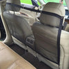 A beige foldable car pet barrier safety net installed across the back seat of a vehicle.