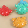 Three colorful squeaky chew toys for dogs shaped like turtles in red, teal, and yellow.