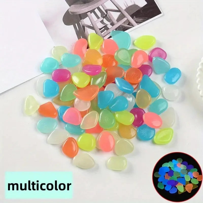 A pile of multicolored glow-in-the-dark decorative stones in various shades of green, pink, orange, and blue.
