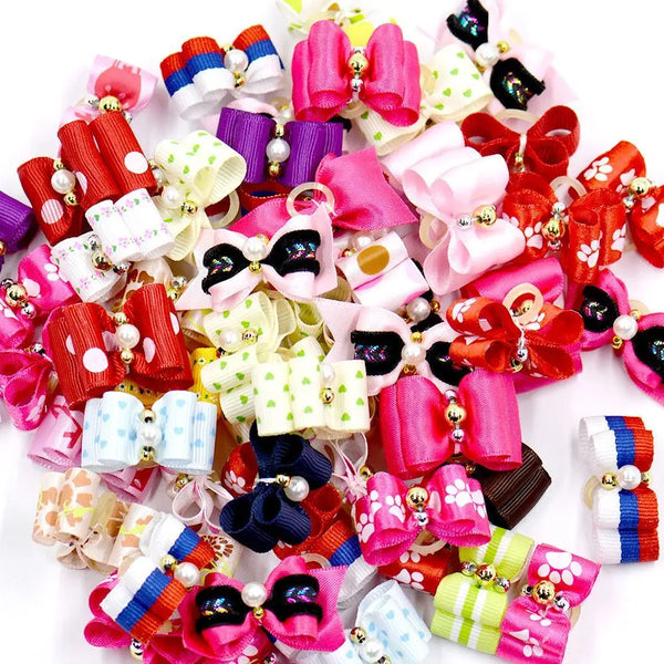 A colorful assortment of handmade fabric bow ties in various pink, red, purple, and white patterns for small pets.