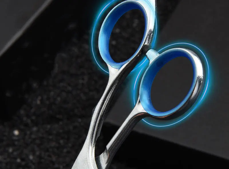 A pair of professional stainless steel pet grooming scissors with glowing blue accents.