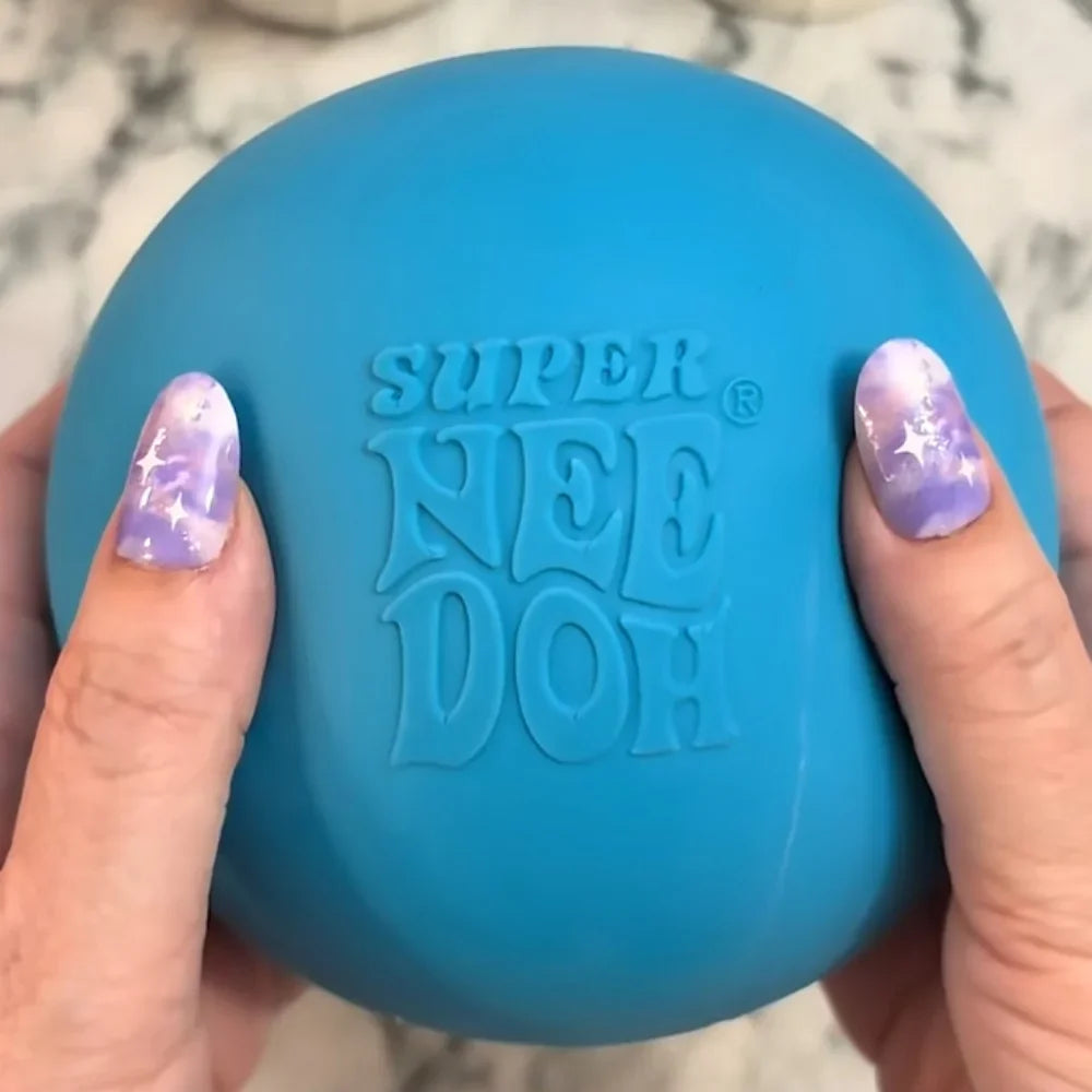 A hand holds a bright blue squishy stress ball with the words SUPER NEED DOH molded into it.