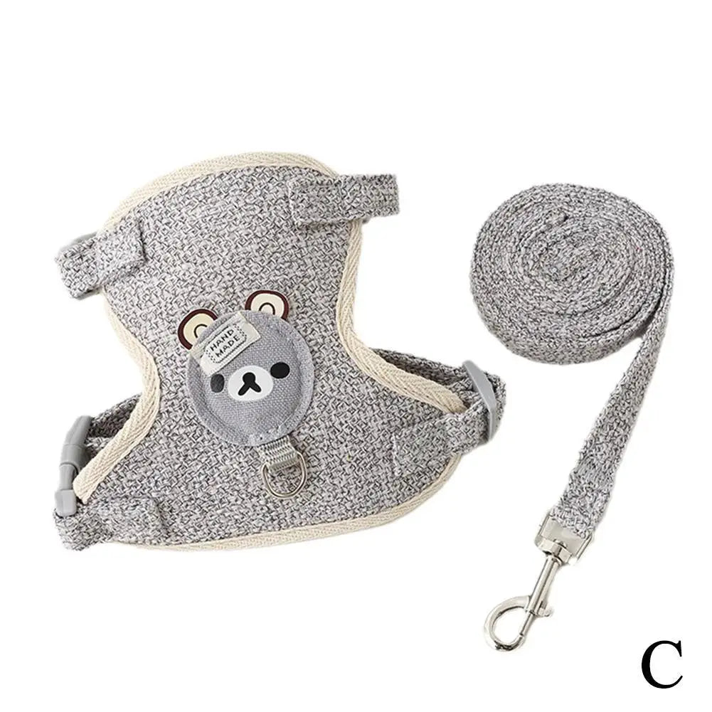 Gray pet leash harness for dogs and cats with a coiled leash attached