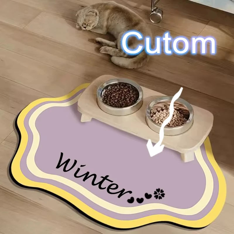 A pet feeding mat with a non-slip base and two bowls of food on a wooden surface.