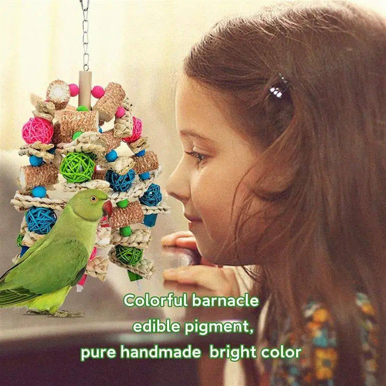 A young girl is looking at a green parrot toy made from colorful, edible pigment and natural wood.