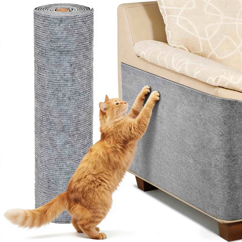 An orange tabby cat stretches its paw against a large gray self-adhesive sofa protector mat.
