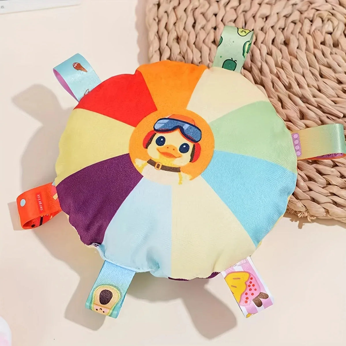 A plush dog toy shaped like a colorful flying disc with a face and fabric petals.