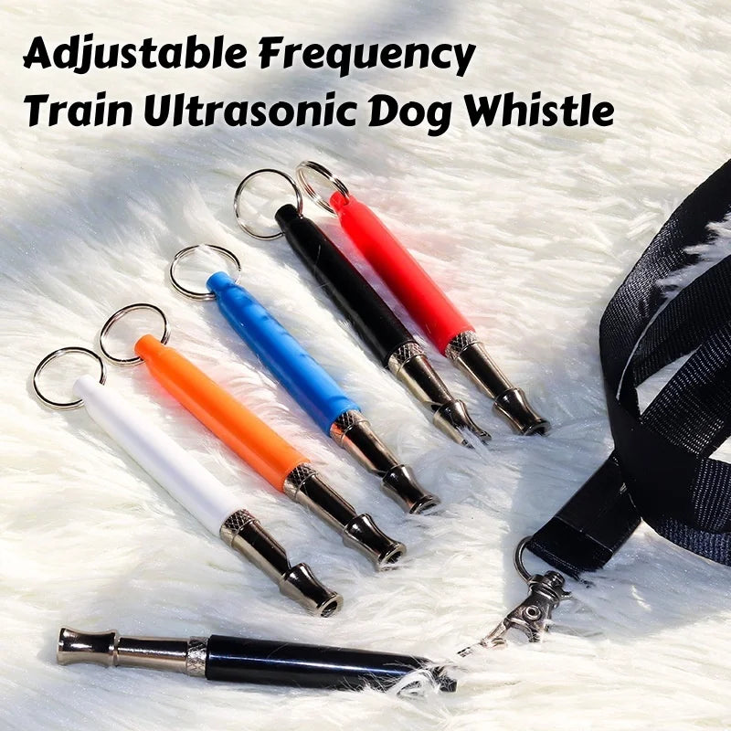 Adjustable frequency train ultrasonic dog whistle with various colored tips displayed on white fur