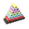 A stack of multi-color continuous roll dog poop bags in various shades of purple, green, and orange.