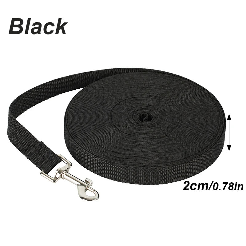 Black nylon dog training leash with a solid color long lead roll.
