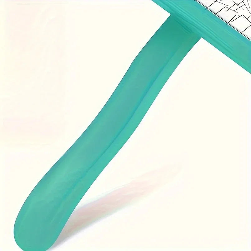 A close-up view of a teal dog slicker brush with a white grid pattern on the handle.