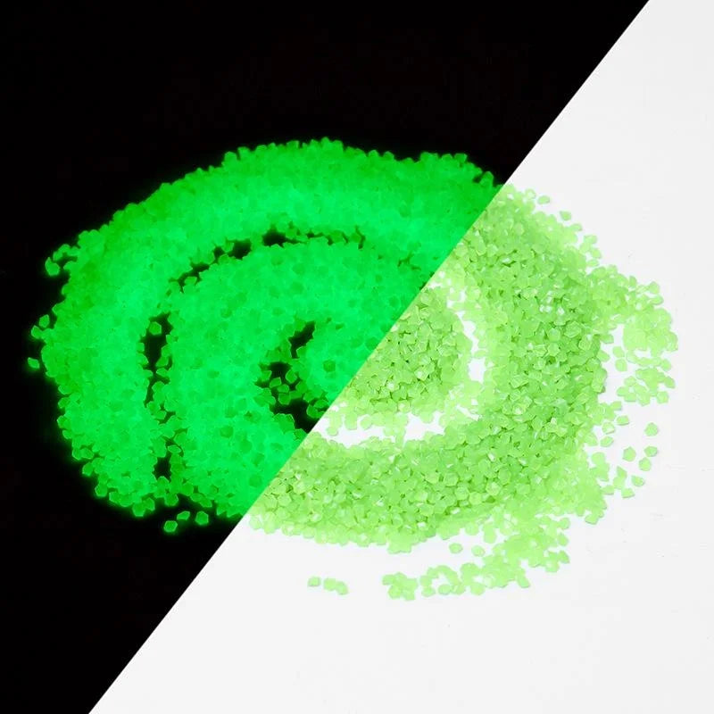 A close-up view of bright green glow-in-the-dark decorative pebbles, showing a swirling pattern against a black and white bac