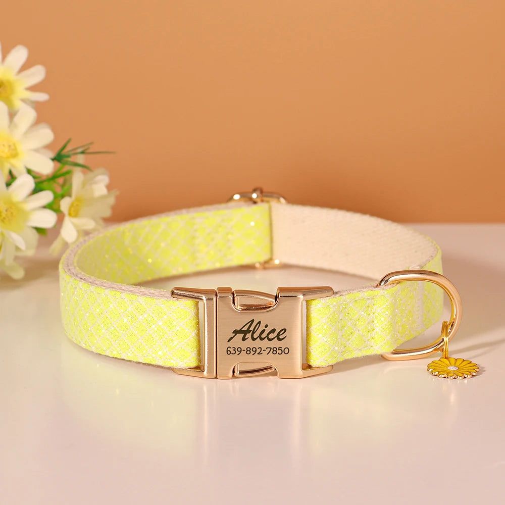 A light yellow textured nylon dog collar with a gold buckle and an engraved name tag.