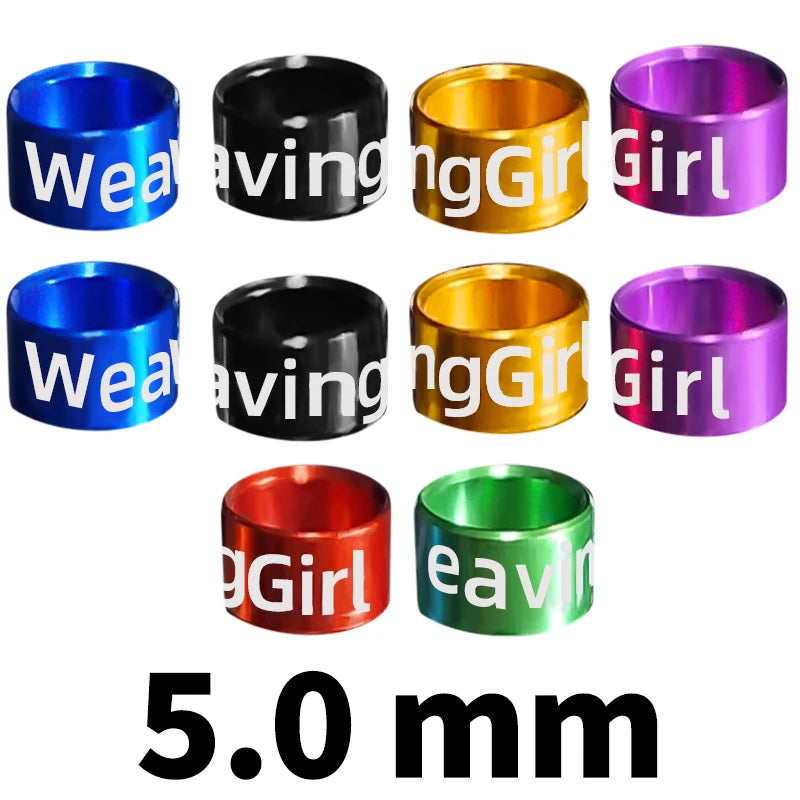 Assorted metal bird identification rings in various colors including blue, black, gold, and purple.