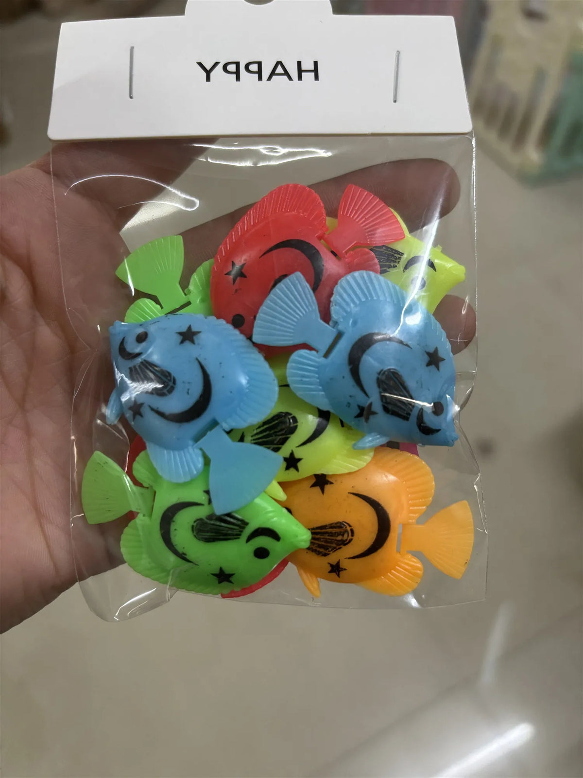 A clear plastic bag contains a set of ten colorful soft rubber goldfish bath toys for kids.