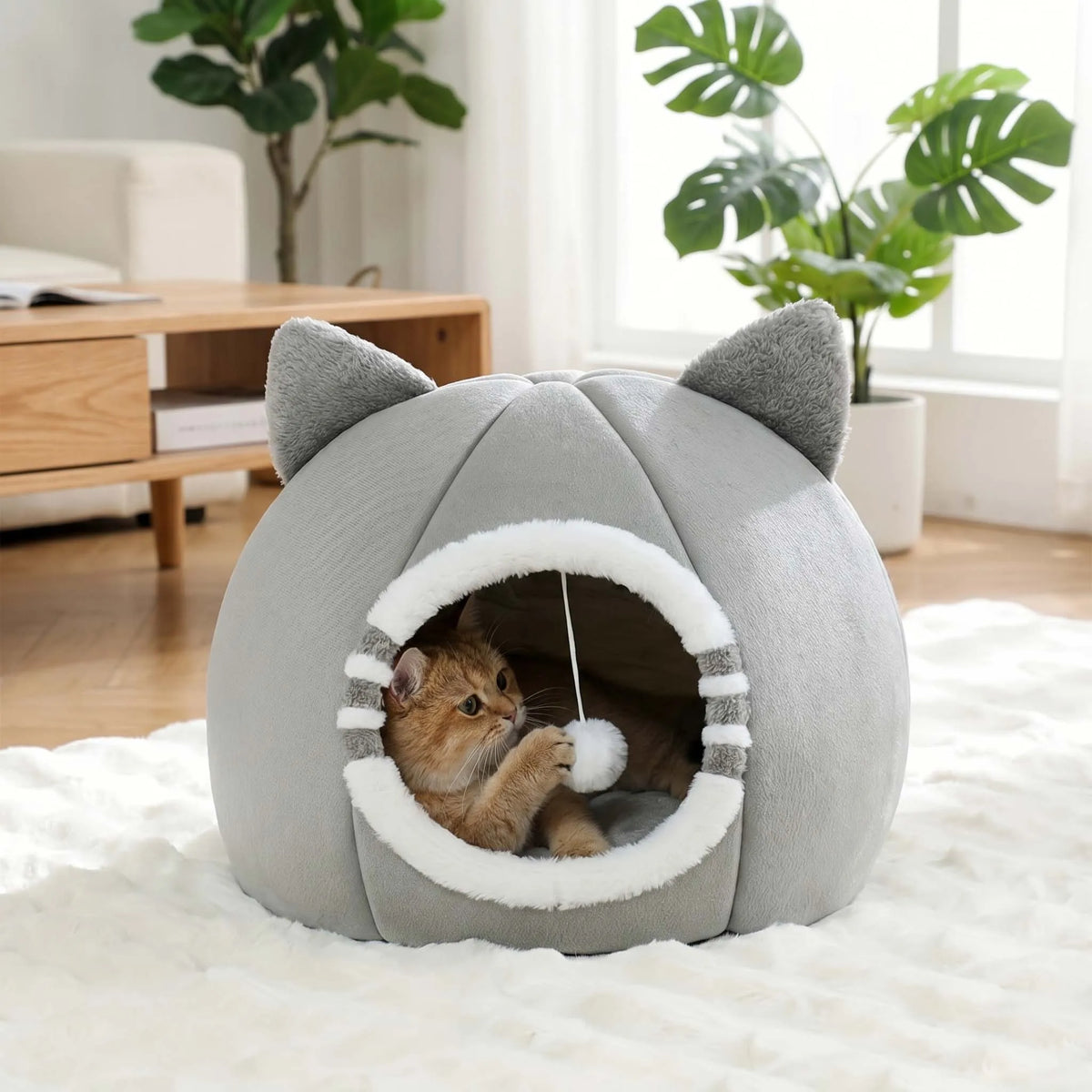 A gray plush tent house shaped like a cat cave with large ears, featuring an entrance for a small pet.