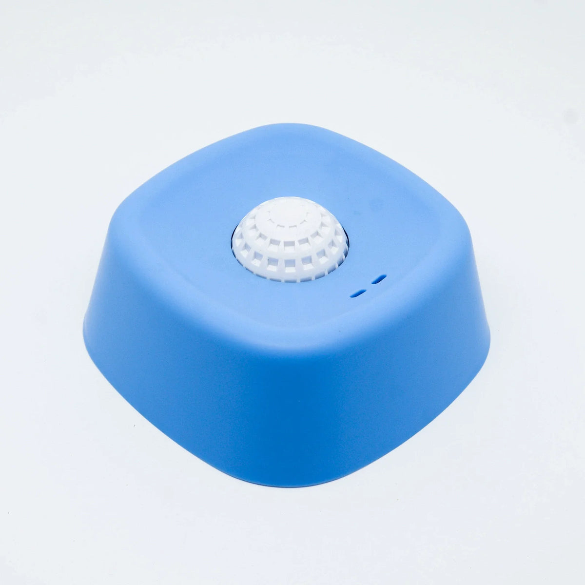 A bright blue non-slip silicone lick mat slow feeder bowl for dogs and cats.