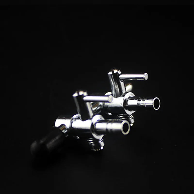 A close-up shot of a stainless steel aquarium air splitter valve with multiple outlets.