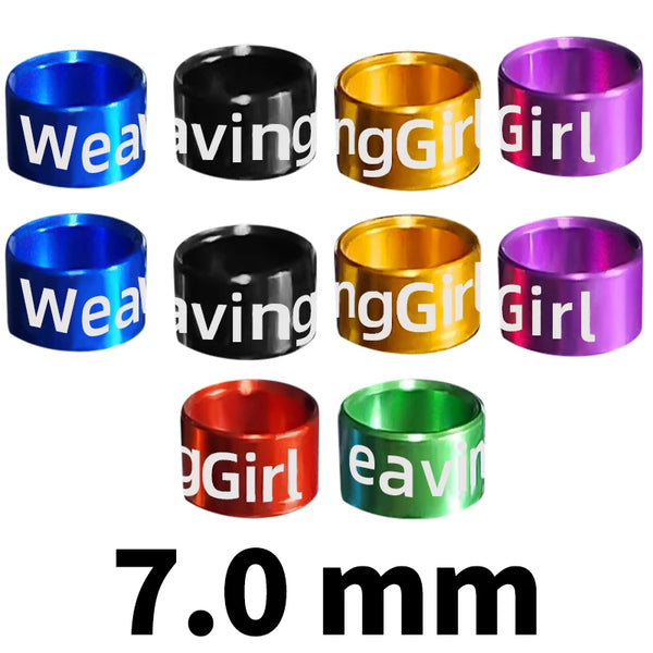 Assorted metal bird identification rings in various colors including blue, black, gold, and purple.