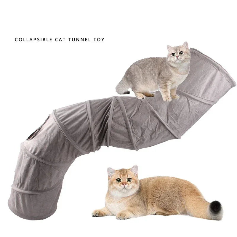 A fluffy ginger cat is shown resting on a gray collapsible cat tunnel toy.