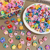 A variety of colorful elastic hair ties and accessories, including cartoon characters and flowers, are displayed on a surface