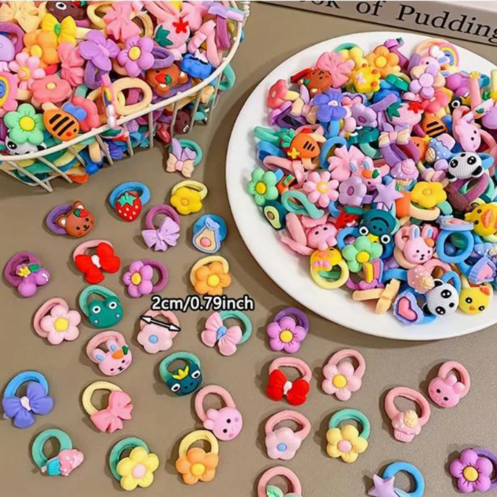 A variety of colorful elastic hair ties and accessories, including cartoon characters and flowers, are displayed on a surface