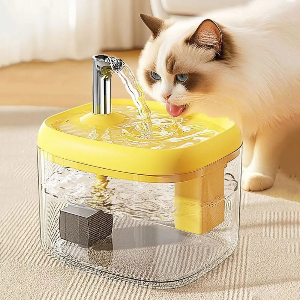 A yellow pet drinking fountain with a clear bowl is being used by a cat.