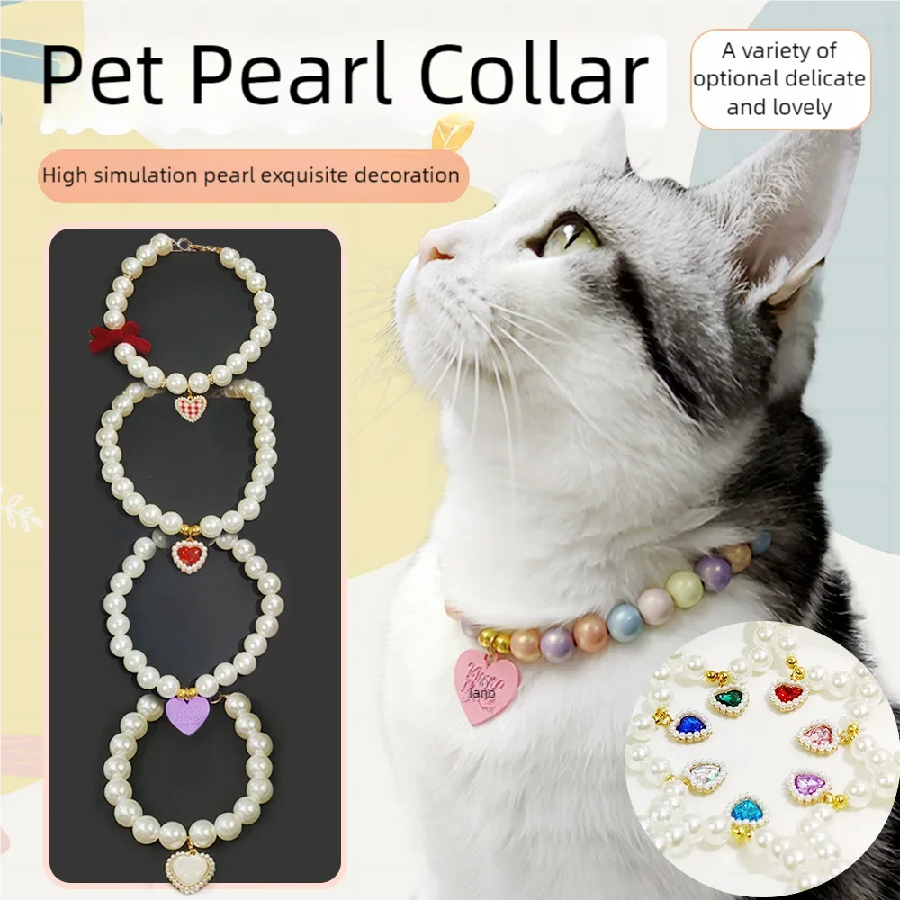 A white cat wearing a delicate pearl collar with colorful rhinestones and beads.