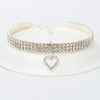 A sparkling rhinestone collar for dogs or cats displayed on a white plate.