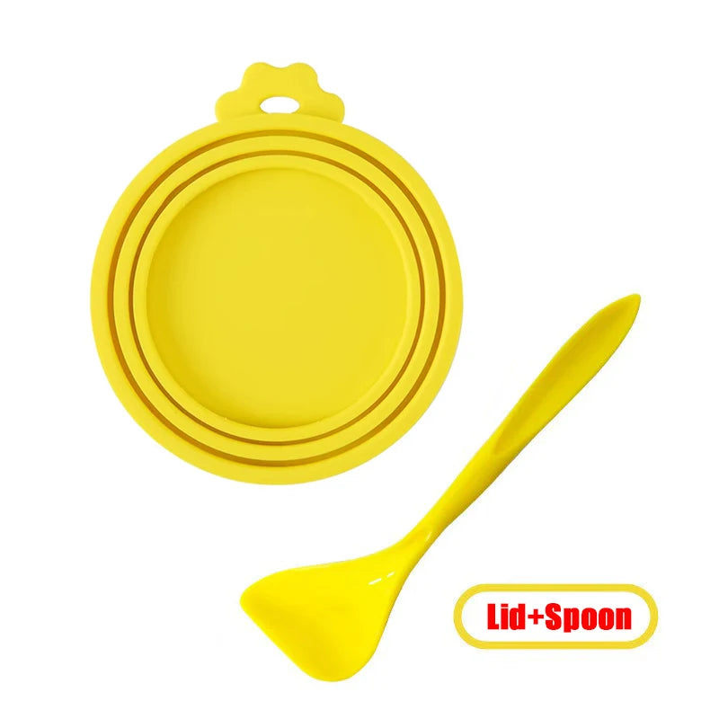 Yellow reusable silicone pet food can lid with a matching spoon