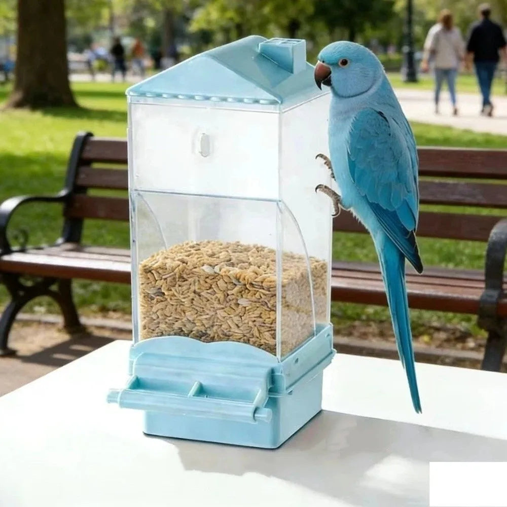 A clear automatic bird feeder with a blue base and a feeding compartment, featuring a blue bird perched on the side.